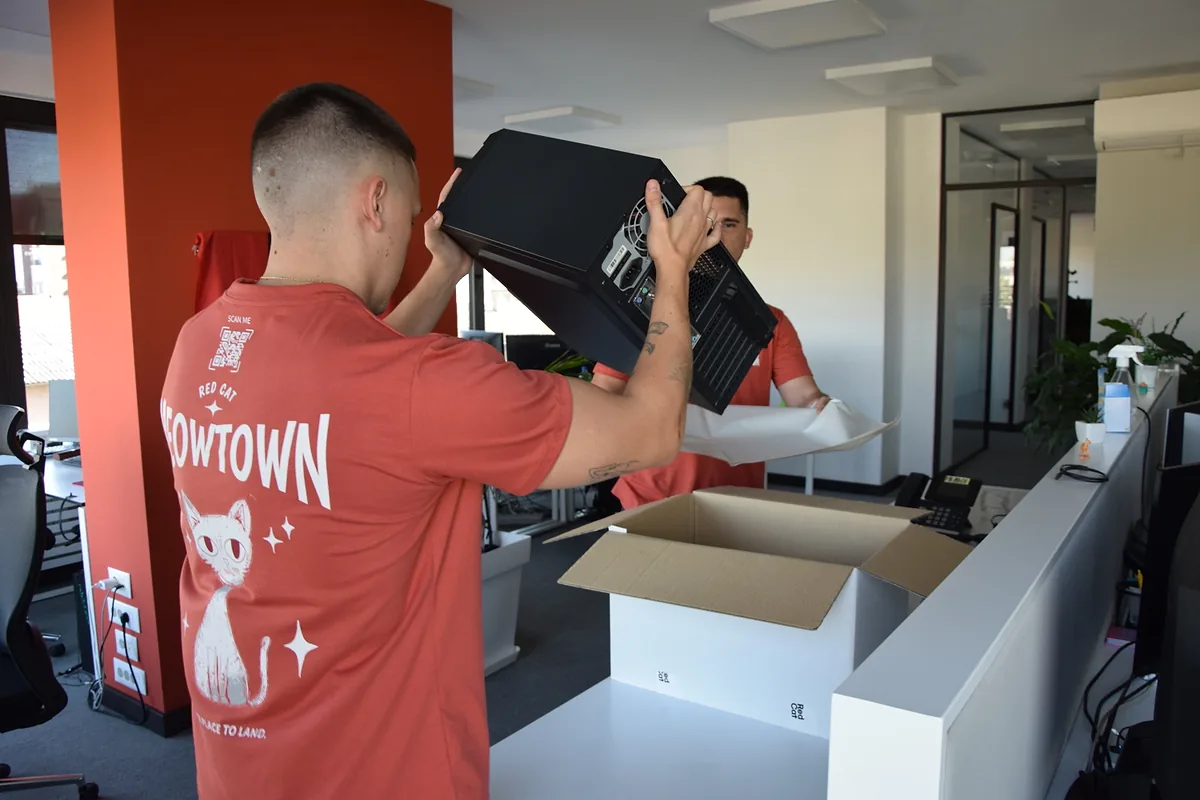 Red Cat business mover packing a computer at the reception desk
