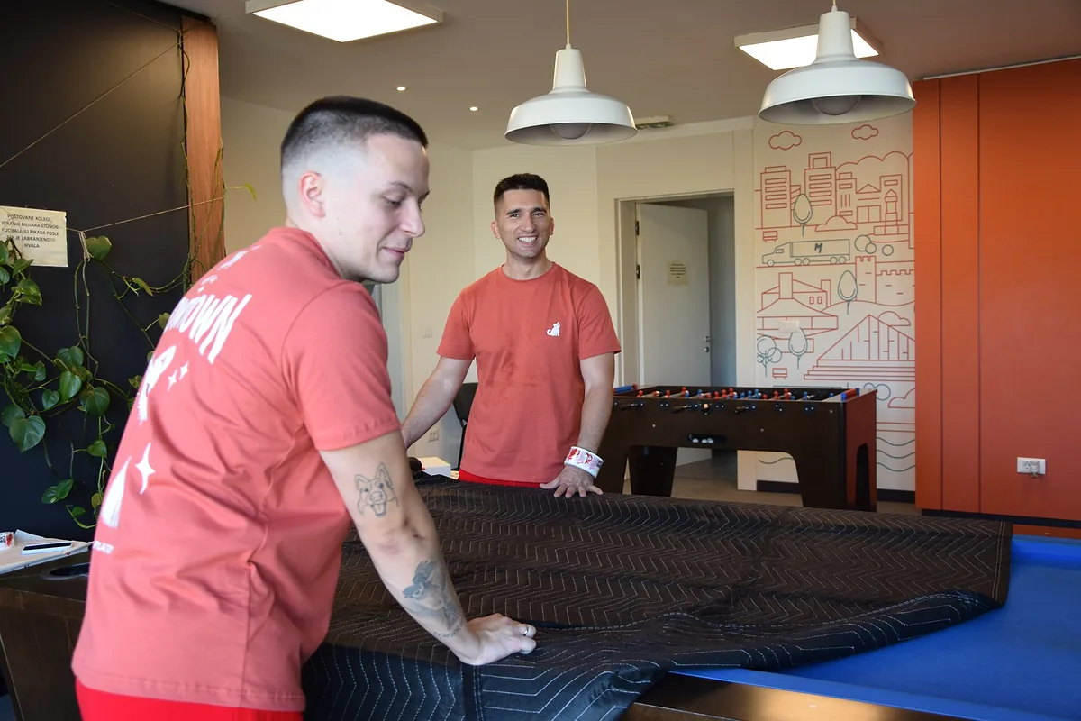Red Cat event movers covering a table with a moving blanket