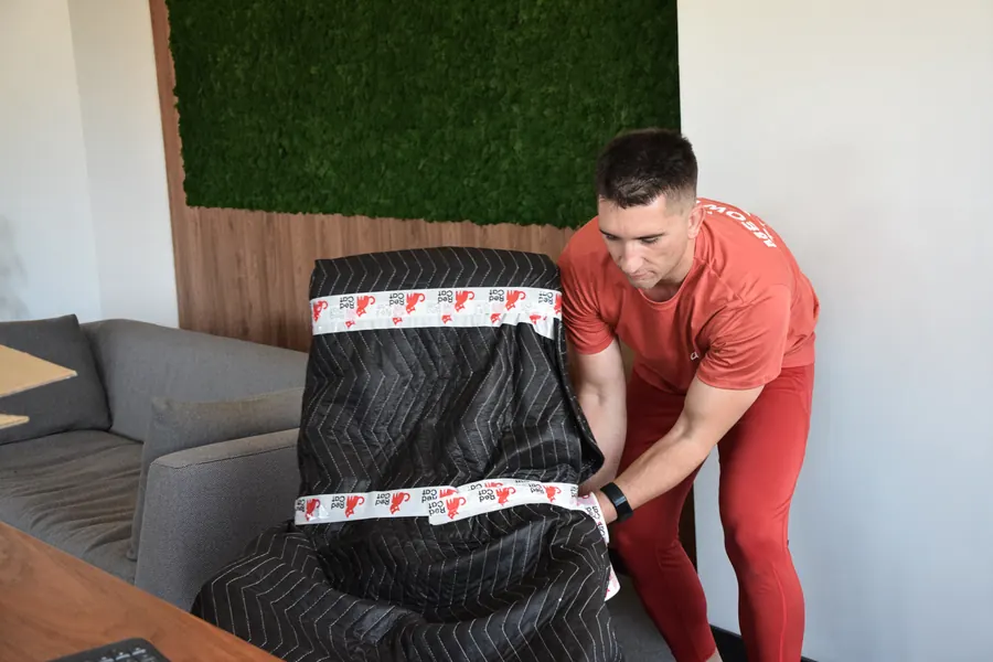 Red Cat local mover pad-wrapping an armchair