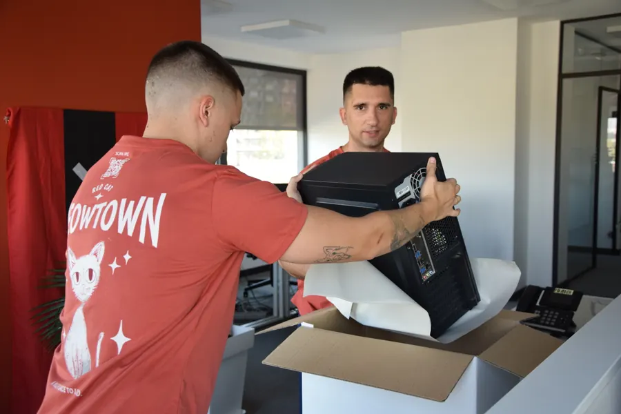 Red Cat office movers packing a computer tower