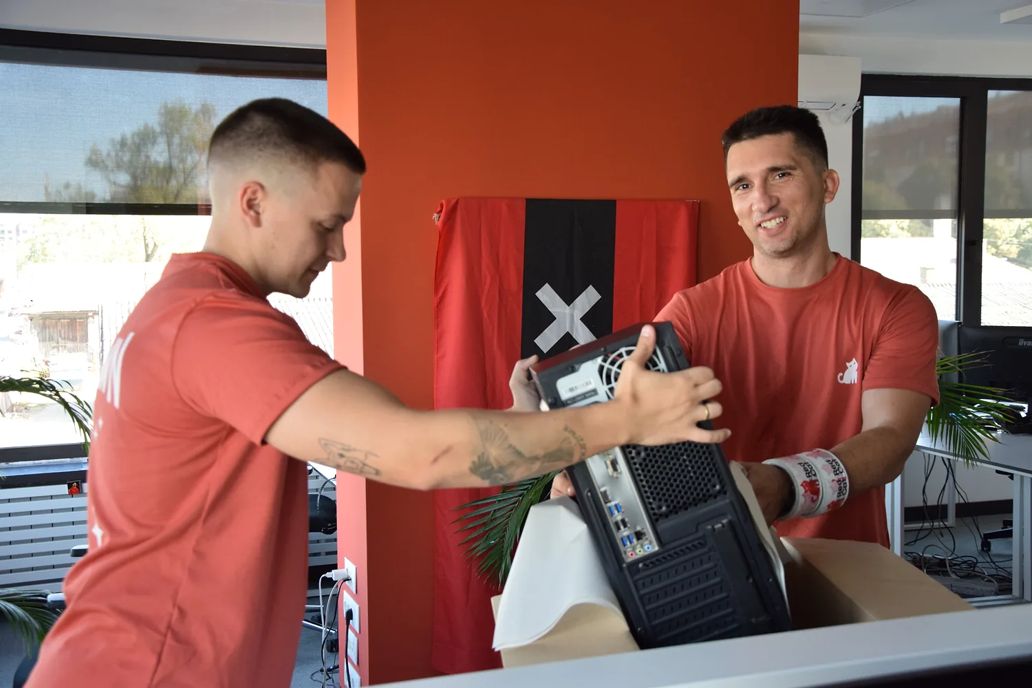 Red Cat office movers packing a computer tower for an office move