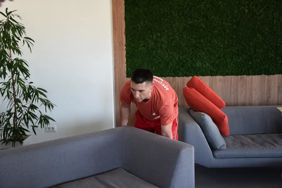 Red Cat mover moving a sectional sofa