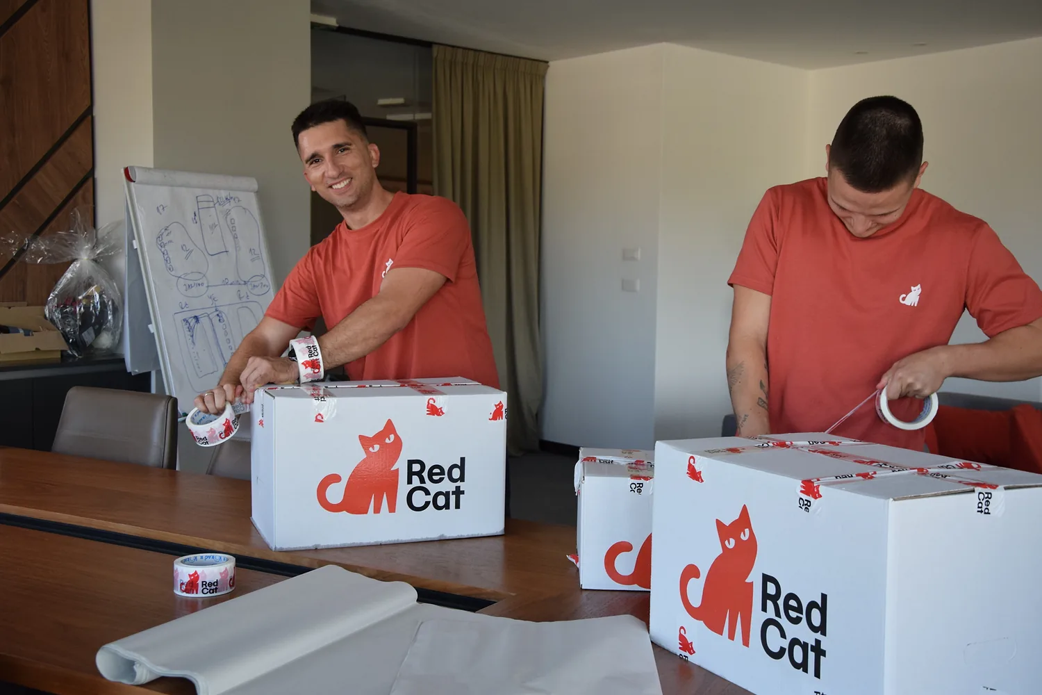 A Red Cat mover taping Red Cat boxes