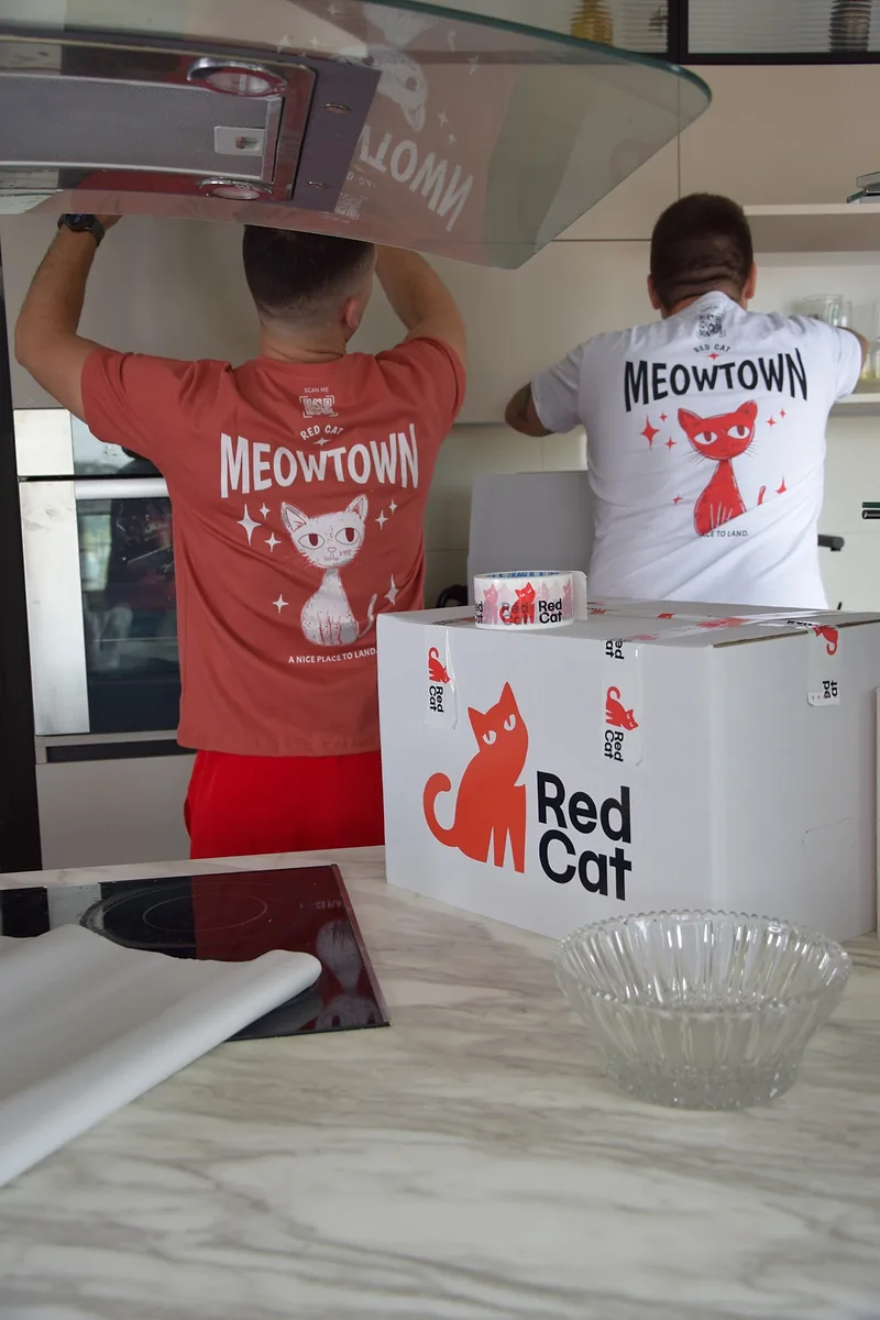 Two Red Cat senior movers packing up a kitchen