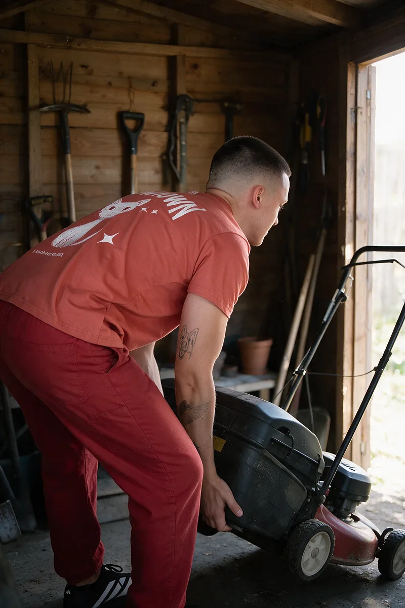 Red Cat shed mover lifting a lawnmower out of a garden shed