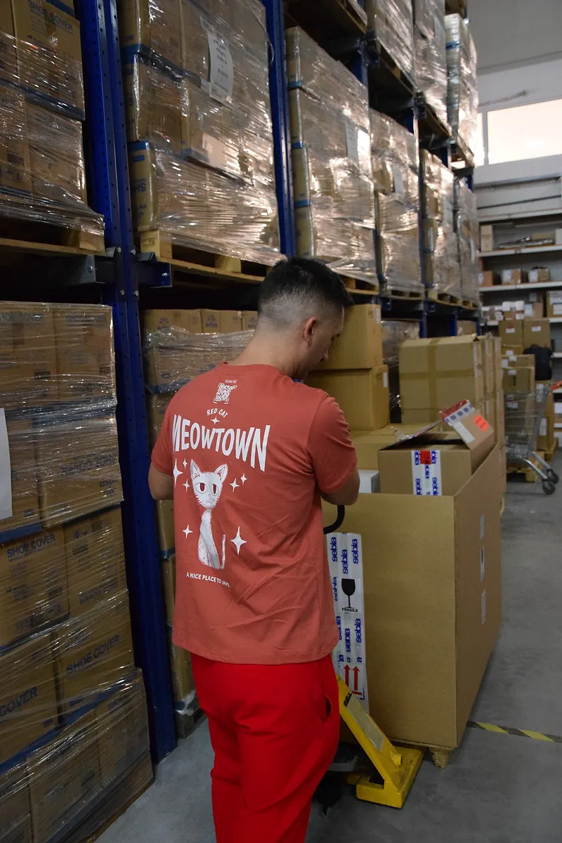 Red Cat warehouse mover loading boxes onto a pallet jack