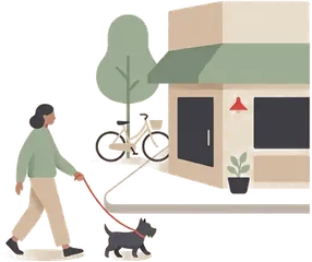 A woman walking her dog past a corner shop